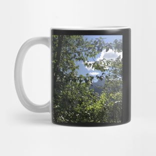 Peeking through trees at Glacier National Park Mug